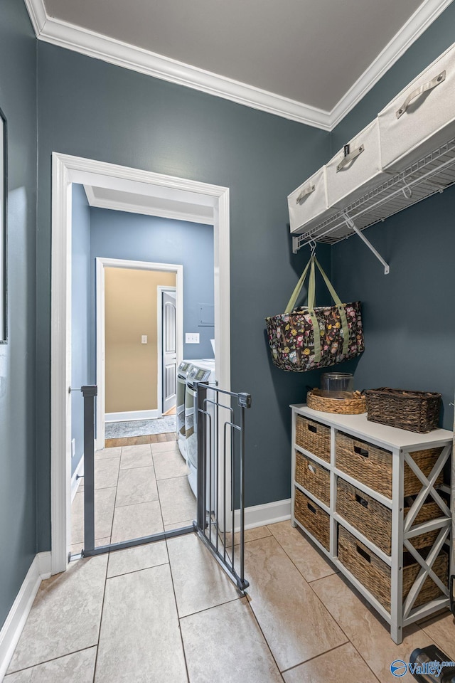 interior space with baseboards, washing machine and dryer, laundry area, and crown molding