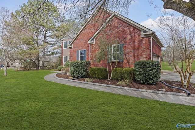 view of property exterior featuring a garage, a yard, and brick siding