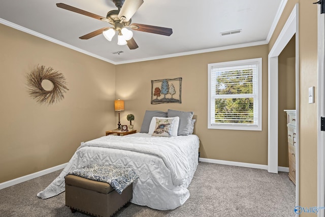 carpeted bedroom featuring visible vents, baseboards, a ceiling fan, and crown molding