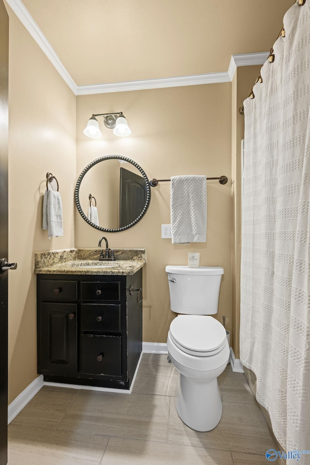 full bathroom featuring baseboards, vanity, crown molding, and toilet