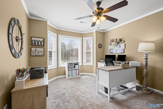 office space featuring visible vents, a ceiling fan, crown molding, baseboards, and light colored carpet