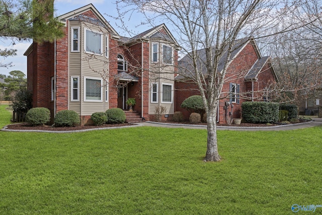 traditional home featuring brick siding and a front lawn