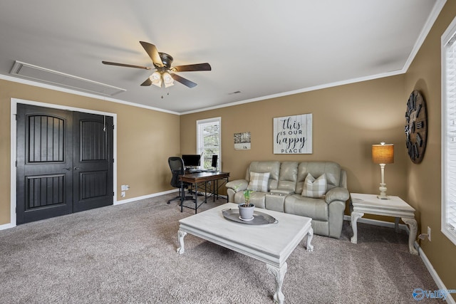 carpeted living room with baseboards, attic access, and crown molding