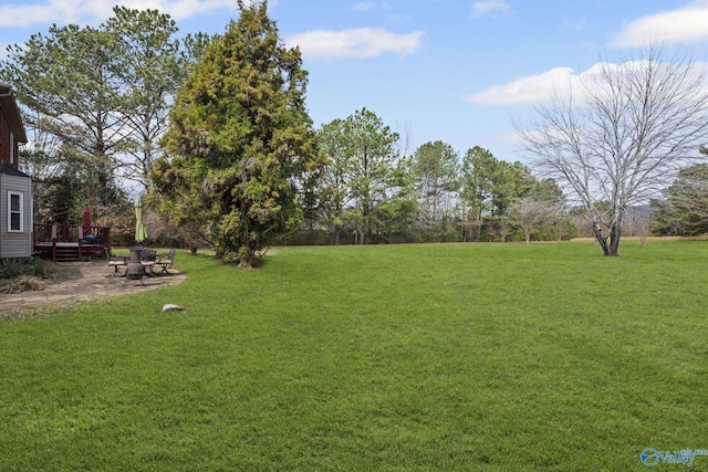 view of yard featuring a deck and a patio area