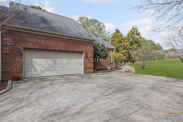 view of property exterior with a yard, brick siding, driveway, and a shingled roof