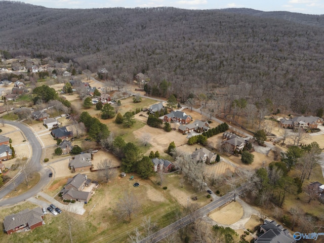 drone / aerial view with a mountain view and a view of trees