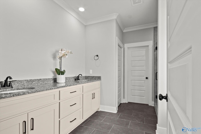 bathroom with tile patterned floors, crown molding, and vanity