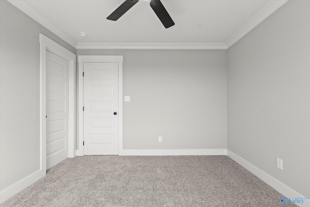 spare room featuring crown molding, ceiling fan, and carpet floors