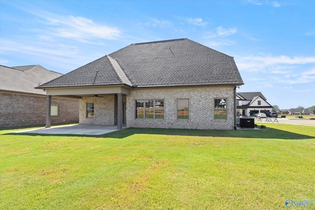 back of house with a lawn, a patio area, and central air condition unit