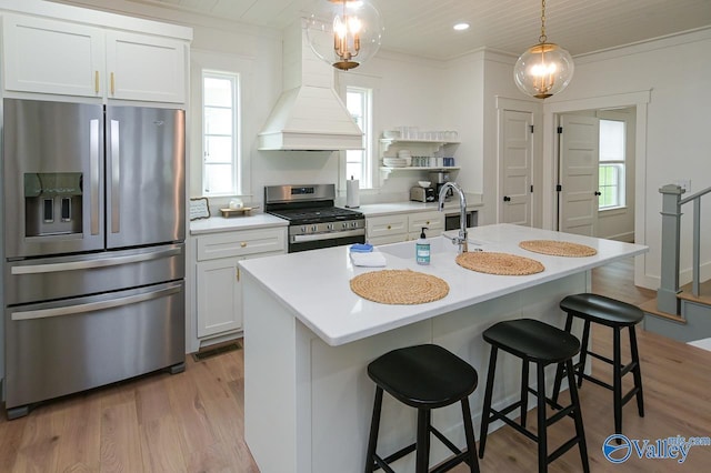 kitchen with custom exhaust hood, light wood-style floors, stainless steel appliances, light countertops, and white cabinets