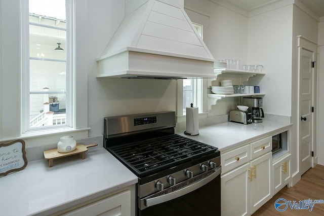 kitchen with premium range hood, a healthy amount of sunlight, open shelves, and stainless steel gas stove