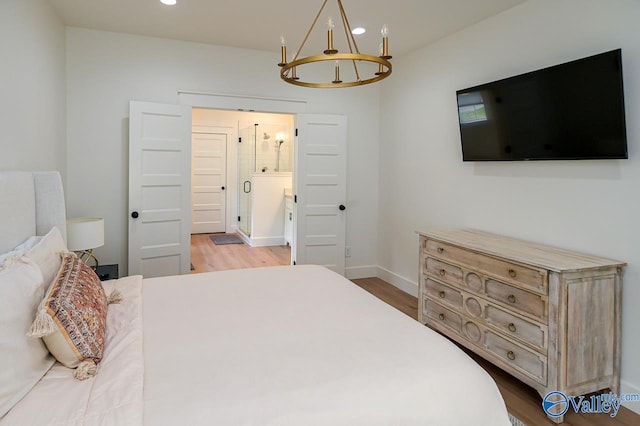 bedroom with baseboards, wood finished floors, recessed lighting, and a chandelier