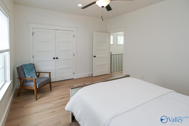 bedroom featuring recessed lighting, light wood-style flooring, a closet, and baseboards