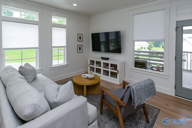 living room with wood ceiling, a wealth of natural light, wood finished floors, and recessed lighting