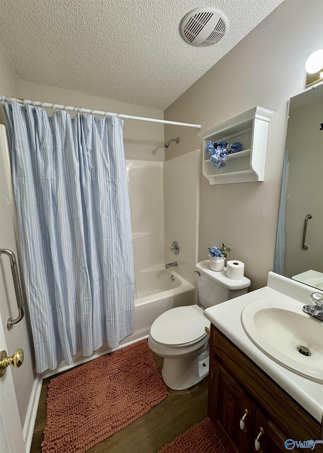 full bath with shower / tub combo, visible vents, toilet, a textured ceiling, and vanity