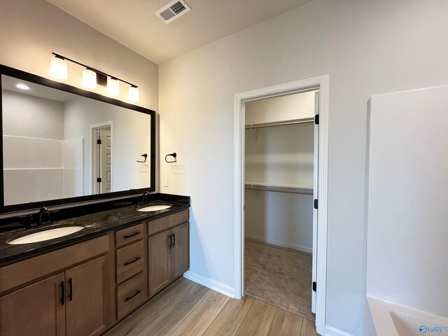 120 Parvin Way Dr, Hazel Green, AL 35750 - full bathroom featuring a walk in closet, double vanity, visible vents, and a sink