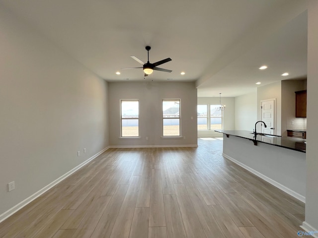 120 Parvin Way Dr, Hazel Green, AL 35750 - unfurnished living room with a sink, light wood finished floors, baseboards, ceiling fan with notable chandelier, and recessed lighting