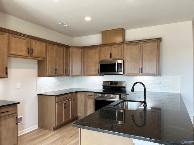 120 Parvin Way Dr, Hazel Green, AL 35750 - kitchen featuring a sink, appliances with stainless steel finishes, a peninsula, dark stone countertops, and visible vents