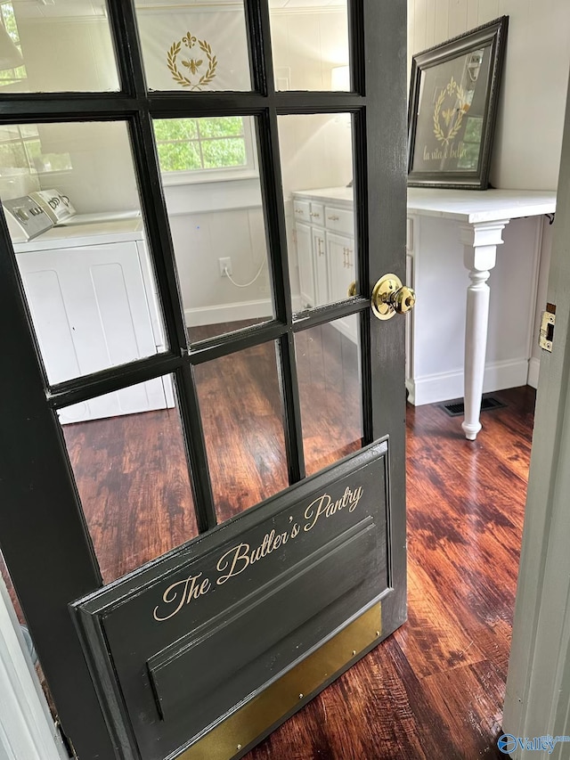2010 Youngs Chapel Rd, Piedmont, AL 36272 - detailed view of washing machine and clothes dryer, wood finished floors, and baseboards