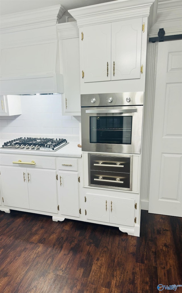 2010 Youngs Chapel Rd, Piedmont, AL 36272 - kitchen featuring stainless steel appliances, white cabinets, dark wood-style flooring, and light countertops