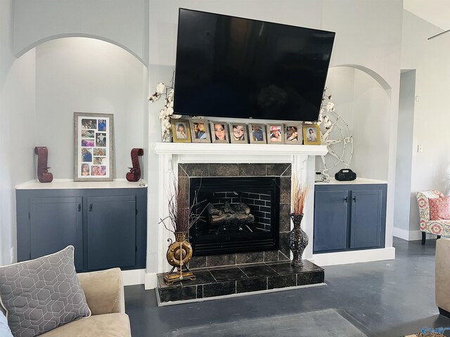 450 County Road 803, Centre, AL 35960 - living area with arched walkways, a tile fireplace, finished concrete flooring, and baseboards