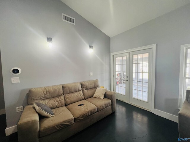 450 County Road 803, Centre, AL 35960 - living area with visible vents, baseboards, concrete flooring, vaulted ceiling, and french doors