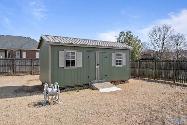 view of outbuilding featuring an outdoor structure and a fenced backyard