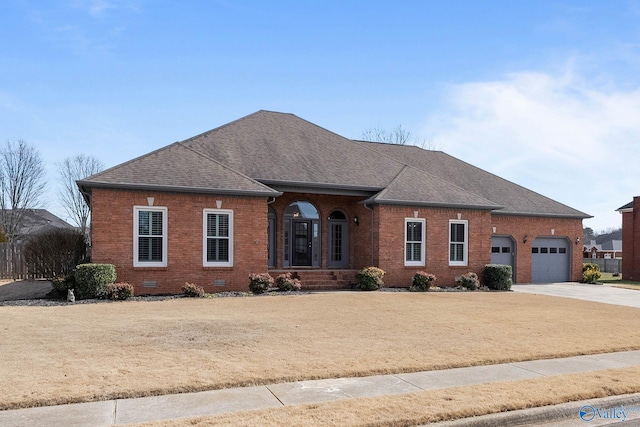 ranch-style house featuring brick siding, roof with shingles, concrete driveway, an attached garage, and crawl space