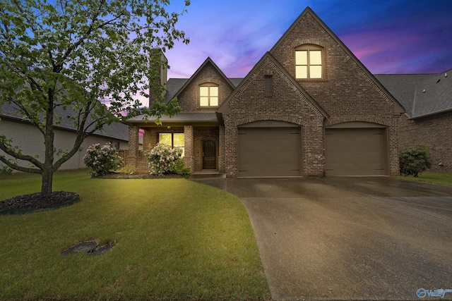 124 Rainwood Dr SW, Huntsville, AL 35824 - view of front of home with a front lawn, roof with shingles, a chimney, brick siding, and driveway