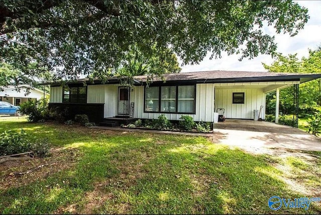 ranch-style home featuring a front yard and a carport