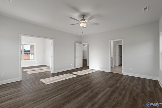 unfurnished bedroom featuring ceiling fan, dark wood-style flooring, baseboards, and visible vents