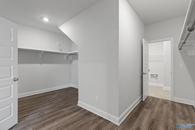 walk in closet with wood finished floors