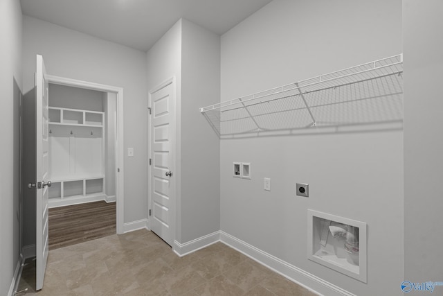 laundry area featuring electric dryer hookup, laundry area, baseboards, and hookup for a washing machine