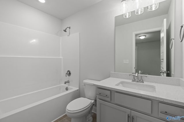 bathroom featuring toilet, vanity, and shower / bathtub combination