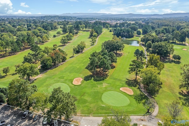 drone / aerial view featuring view of golf course and a water and mountain view