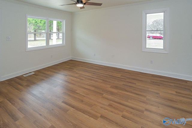 unfurnished room with crown molding, wood-type flooring, and ceiling fan