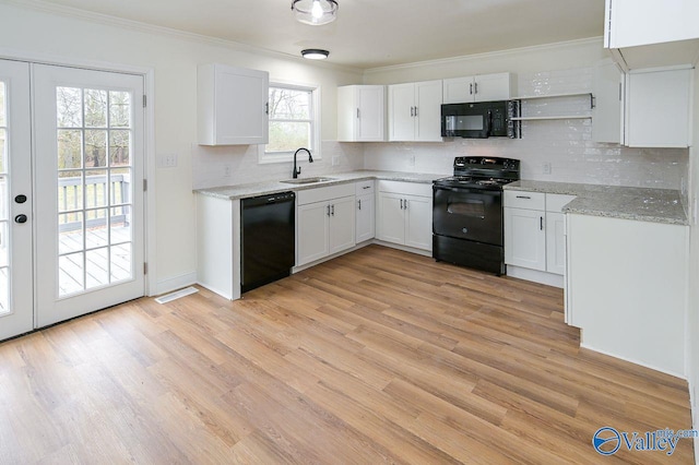 kitchen featuring light hardwood / wood-style flooring, black appliances, sink, and white cabinets