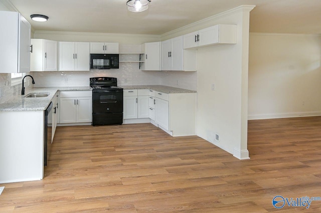 kitchen featuring sink, black appliances, light wood-type flooring, white cabinets, and tasteful backsplash