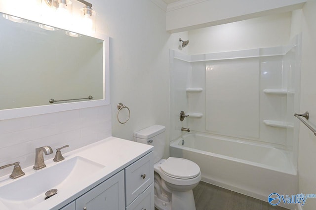 full bathroom featuring  shower combination, decorative backsplash, toilet, vanity, and ornamental molding