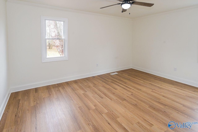 unfurnished room featuring ornamental molding and light wood-type flooring