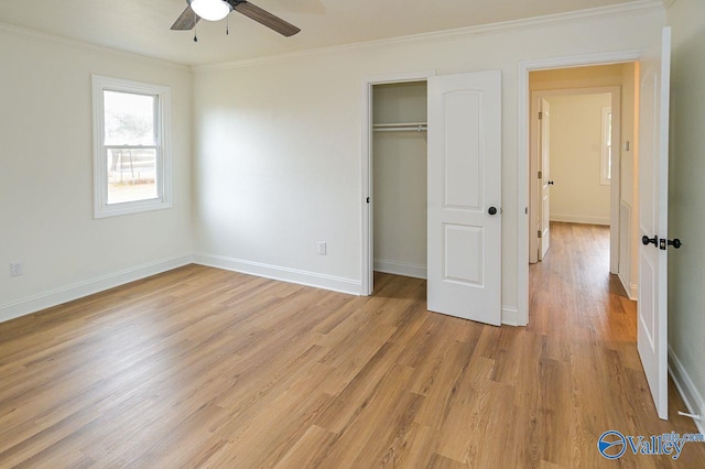 unfurnished bedroom with a closet, ceiling fan, crown molding, and light hardwood / wood-style floors