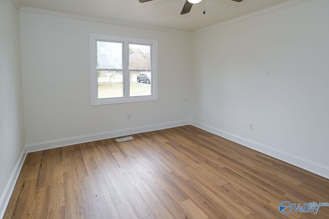 spare room featuring ornamental molding, hardwood / wood-style floors, and ceiling fan