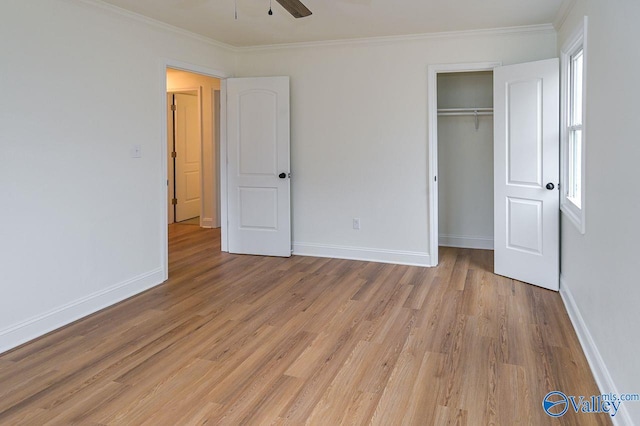 unfurnished bedroom with light hardwood / wood-style flooring, a closet, ornamental molding, and ceiling fan