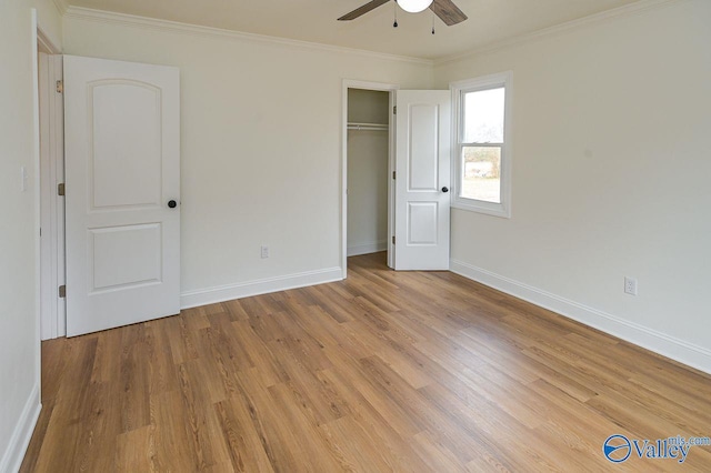 unfurnished bedroom featuring light hardwood / wood-style floors, a closet, ornamental molding, and ceiling fan