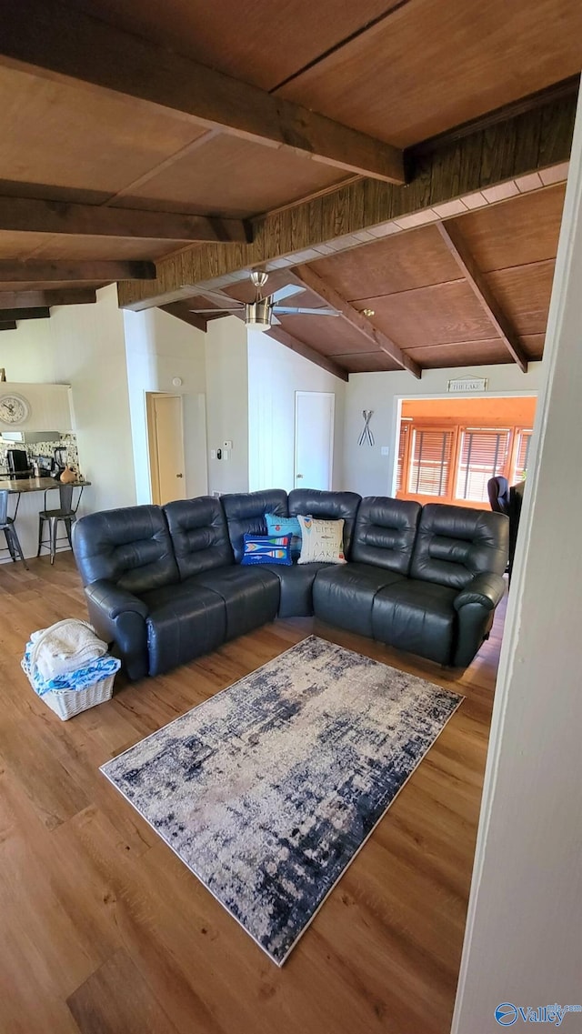 living room with wood finished floors, ceiling fan, lofted ceiling with beams, and wood ceiling