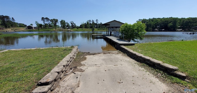 dock area with a water view and a lawn