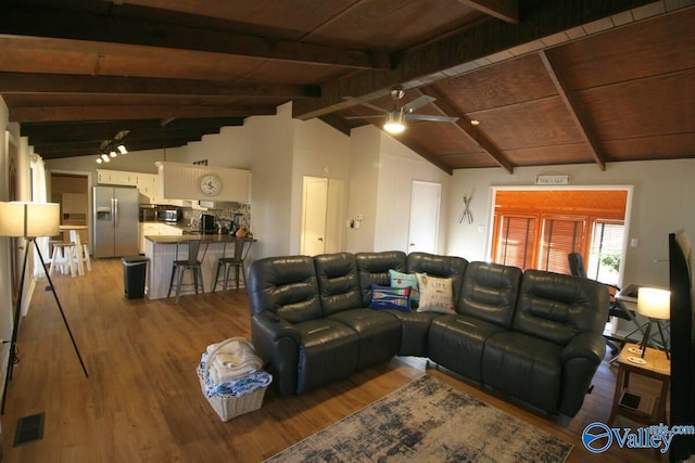 living room featuring wood finished floors, visible vents, vaulted ceiling with beams, and wooden ceiling