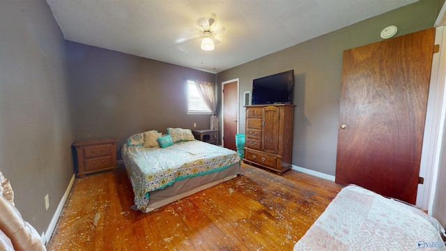 1303 7th Ave, Athens, AL 35611 - bedroom with wood finished floors, baseboards, and a ceiling fan
