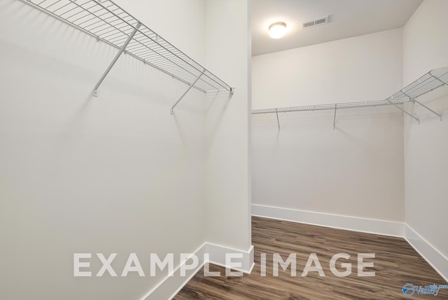 spacious closet featuring hardwood / wood-style floors