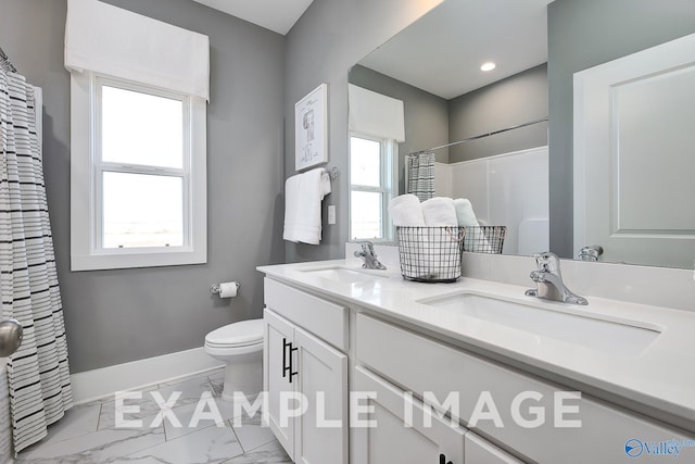 bathroom with toilet, curtained shower, and vanity